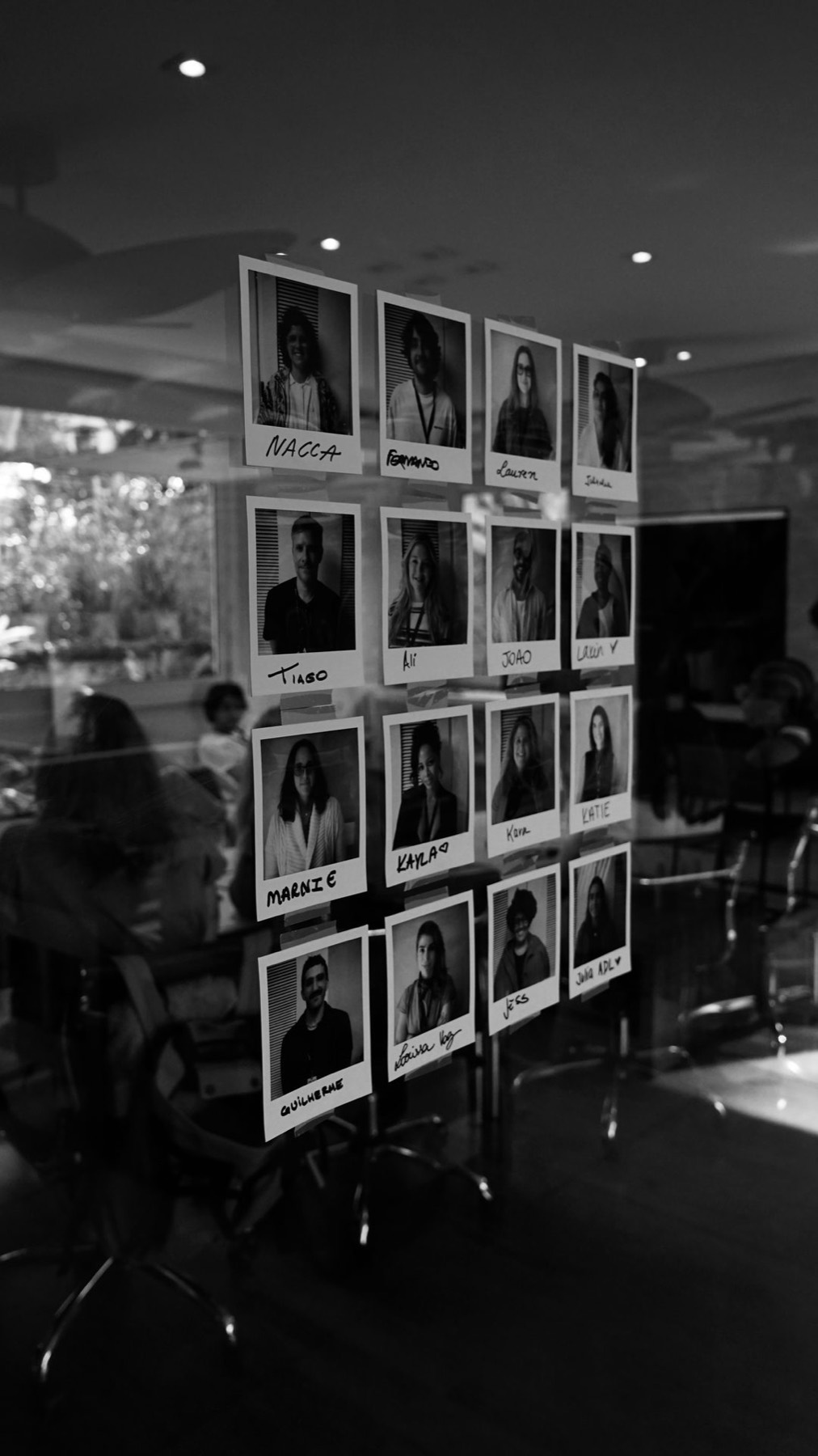 A wall of instant portraits, one handwritten name under each
